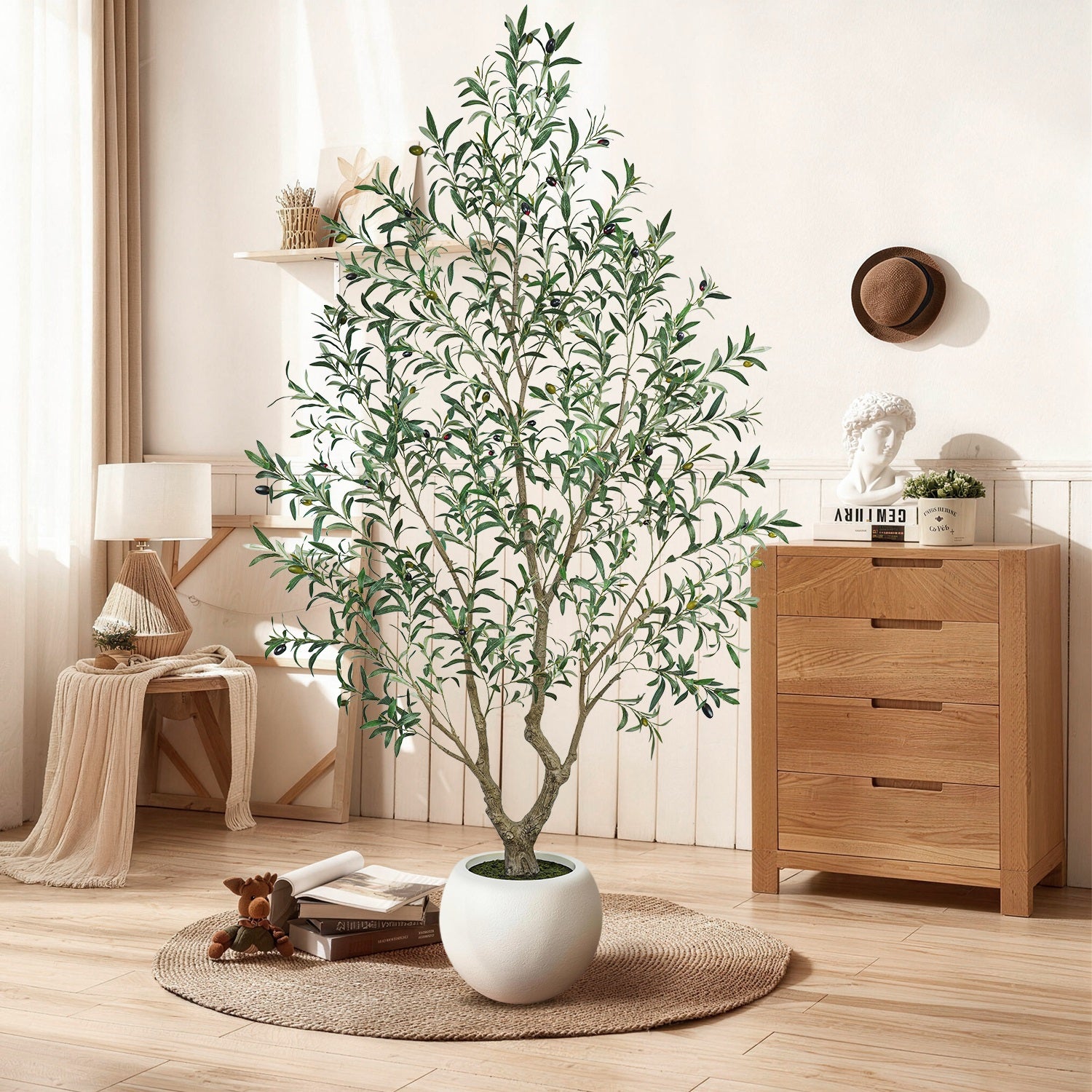 Living room with a large potted plant, wooden cabinet, and decorative items.